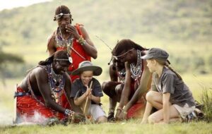 Travelers visiting a Maasai community during a Kenya safari with Mambo Gorilla Safaris