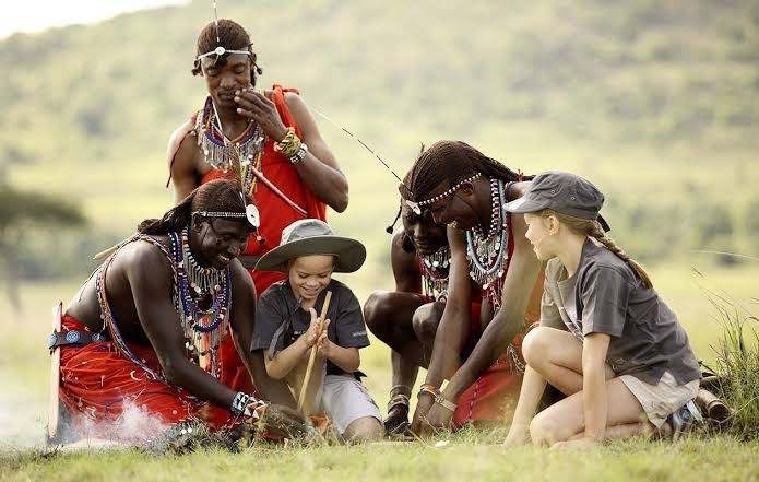 Travelers visiting a Maasai community during a Kenya safari with Mambo Gorilla Safaris