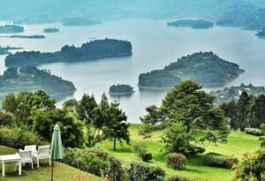 Romantic honeymoon at Lake Bunyonyi in Uganda with a canoe on calm water and terraced green hills