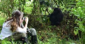 Traveler participating in a community conservation activity during a Uganda gorilla trek
